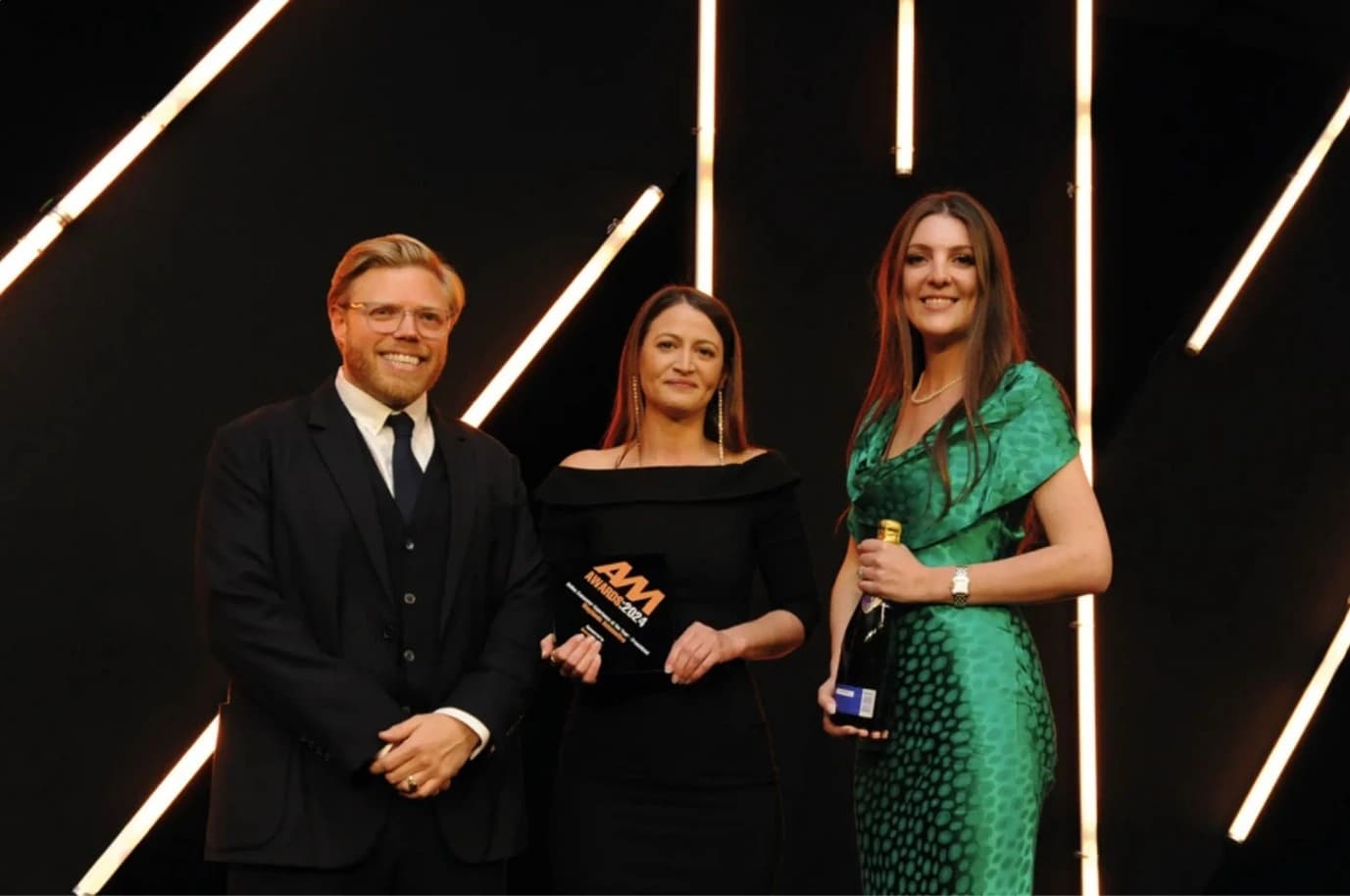Jessica Potts presenting Workshop of the Year award 2024 at AM awards alongside comedian Rob Beckett