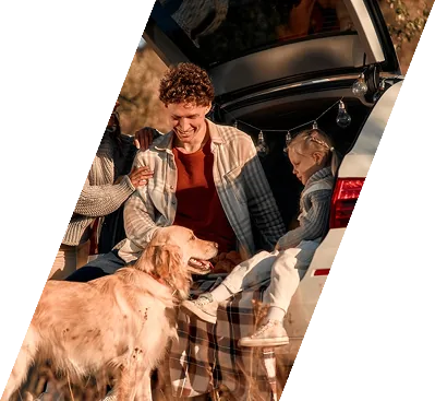 Family with dog at car boot